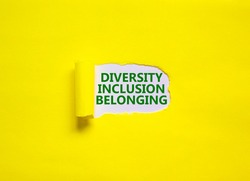 Diversity, inclusion, belonging symbol. Words 'Diversity, inclusion, belonging' appearing behind torn yellow paper. Yellow background. Business, diversity, inclusion, belonging concept, copy space.