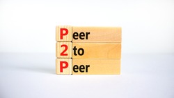 P2P, peer  symbol. Wooden blocks with concept words 'P2P, peer to peer'. Beautiful white background, copy space. Business and P2P, peer  concept.