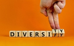 Diversity or diversify symbol. Businessman turns wooden cubes and changes the word 'diversify' to 'diversity'. Beautiful orange background, copy space. Business and diversity or diversify concept.