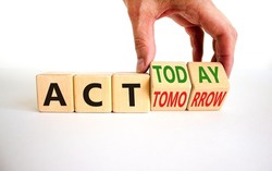 Act today not tomorrow symbol. Businessman turns wooden cubes and changes words act tomorrow to act today. Beautiful white table, white background. Business, act today or tomorrow concept, copy space.