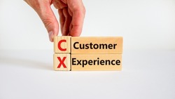 CX customer experience symbol. Concept words 'CX customer experience' on wooden blocks on white table, white background, copy space. Businessman hand. Business and CX customer experience concept.