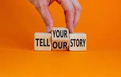 Tell our or your story. Businessman turns wooden cubes, changes words tell our story to tell your story. Beautiful orange background, copy space. Business, storytelling and our or your story concept.
