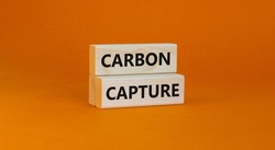Time to carbon capture symbol. Wooden blocks with words 'Carbon capture'. Beautiful orange background. Business, ecology and carbon capture concept. Copy space.