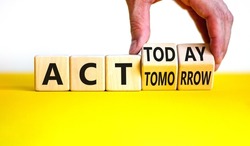Act today not tomorrow symbol. Businessman turns wooden cubes, changes words act tomorrow to act today. Beautiful yellow table, white background. Business, act today or tomorrow concept, copy space.