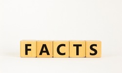 Facts symbol. The concept word 'facts' on wooden cubes. Beautiful white table, white background, copy space. Business, fact and facts concept.