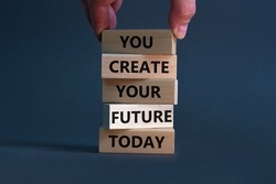 You create your future today symbol. Wooden blocks, words 'You create your future today'. Businessman hand. Beautiful grey background, copy space. Business, motivational and create future concept.