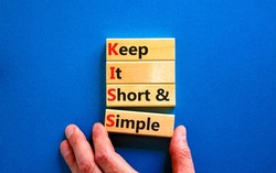 KISS keep it short and simple symbol. Concept words KISS keep it short and simple wooden blocks. Beautiful blue table, blue background. Business KISS keep it short and simple concept. Copy space.