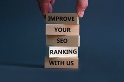 Improve your SEO ranking with us symbol. Wooden blocks with words Improve your SEO ranking with us. Businessman hand. Beautiful grey background, copy space. Business, improve SEO ranking concept.