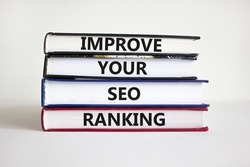Improve SEO ranking symbol. Concept words 'Improve your SEO ranking' on books on a beautiful white background. Businessman hand. Business, Improve your SEO ranking concept.