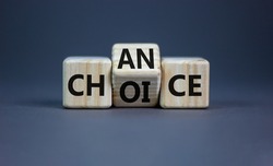 Choice and chance symbol. Businessman turns the wooden cube and changes the word choice to chance. Beautiful grey table, grey background, copy space. Business and choice and chance concept.
