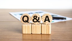 Q and A, questions and answers symbol. Concept words Q and A questions and answers on wooden circles on a beautiful white background. Business and Q and A questions and answers concept.