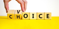Voice and choice symbol. Businessman turns wooden cubes and changes the concept word choice to voice. Beautiful yellow table, white background, copy space. Business and voice and choice concept.