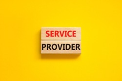 Service provider symbol. Concept words Service provider on wooden blocks on a beautiful yellow table yellow background. Business services and service provider concept, copy space.