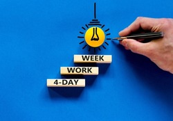 4-day work week symbol. Concept words 4-day work week on wooden blocks on beautiful blue table blue background. Businessman hand. Copy space. Business and 4-day work week and short workweek concept.