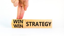 Win-win strategy symbol. Businessman turns wooden cubes with words win win strategy. Beautiful white table, white background. Business, win-win strategy concept. Copy space.
