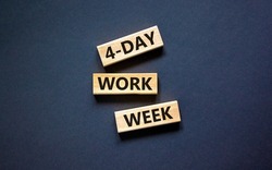 4-day work week symbol. Concept words 4-day work week on wooden blocks on beautiful black table black background. Copy space. Business and 4-day work week and short workweek concept.