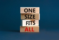 One size fits all symbol. Concept words One size fits all on wooden blocks. Beautiful grey table grey background. One size fits all business concept. Copy space.