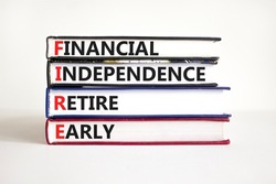 FIRE financial independence retire early symbol. Concept words FIRE financial independence retire early on books. White background. Business FIRE financial independence retire early concept.