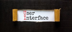 UI user interface symbol. Concept words UI user interface on white paper. Beautiful black background. Copy space. Business and UI user interface concept.