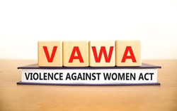 VAWA violence against women act symbol. Concept words VAWA violence against women act on cubes. Beautiful white background. Business, motivational VAWA violence against women act concept.