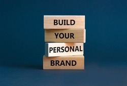 Build your personal brand symbol. Concept words Build your personal brand on wooden blocks. Beautiful grey table grey background. Build your personal brand business concept. Copy space.