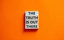 The truth is out there symbol. Concept words The truth is out there on wooden blocks. Beautiful orange table orange background. The truth is out there business concept. Copy space.