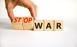 Stop war symbol. Businessman turns cubes and changes concept words War to Stop war. Beautiful white table white background. Business and stop war concept. Copy space.