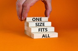 One size fits all symbol. Concept words One size fits all on wooden blocks. Businessman hand. Beautiful orange table orange background. One size fits all business concept. Copy space.