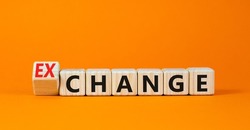 Change or exchange symbol. Turned wooden cubes and changed the concept word Change to Exchange. Beautiful orange table orange background. Copy space. Business and change or exchange concept.