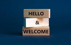 Hello and welcome symbol. Concept words Hello and welcome on wooden blocks. Beautiful grey background. Business hello and welcome concept. Copy space.