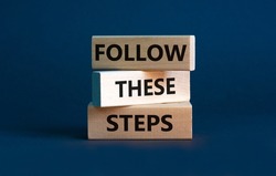 Follow these steps symbol. Concept words Follow these steps on wooden blocks. Beautiful grey background. Business and follow these steps concept. Copy space.