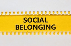 Social belonging symbol. Yellow and white paper with concept words Social belonging on beautiful white background. Business political social belonging concept. Copy space.
