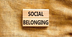 Social belonging symbol. Wooden blocks with concept words Social belonging on beautiful canvas background. Business political social belonging concept. Copy space.