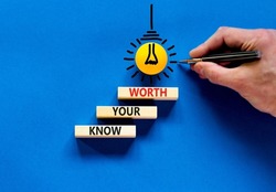 Know your worth symbol. Concept words Know your worth on wooden blocks. Businessman hand. Beautiful blue table blue background. Business and know your worth concept. Copy space.