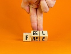 Feel free symbol. Businessman turns wooden cubes with concept words 'Feel free' on a beautiful orange background. Copy space. Psychology and feel free concept.