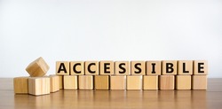 Accessible symbol. The word accessible on wooden cubes. Beautiful wooden table, white background. Business and accessible concept. Copy space.