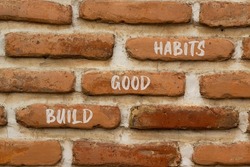 Build good habits symbol. Concept words Build good habits on brick wall. Beautiful brick wall background. Psychological business and build good habits concept. Copy space.
