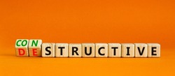 Destructive or constructive symbol. Turned wooden cubes and changed the concept word Destructive to Constructive. Beautiful orange background. Business constructive or destructive concept. Copy space.