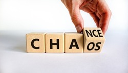 Chance or chaos symbol. Businessman turns a cube and changes the word 'chaos' to 'chance'. Beautiful white background, copy space. Business, chaos or chance concept.