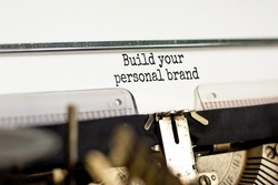 Build your personal brand symbol. Concept words Build your personal brand typed on retro typewriter. Beautiful white background. Build your personal brand business concept. Copy space.