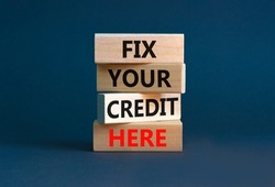 Fix your credit here symbol. Concept words Fix your credit here on wooden blocks on a beautiful grey table grey background. Business, finacial and fix your credit here concept.