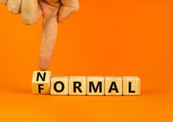 Formal or normal symbol. Businessman turns wooden cubes and changes the concept word formal to normal. Beautiful orange table orange background. Business formal or normal concept. Copy space.