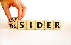 Insider or outsider symbol. Businessman turns wooden cubes and changes the concept word Insider to Outsider. Beautiful white table white background. Business insider or outsider concept. Copy space.