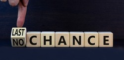 No or last chance symbol. Turned wooden cubes and changed concept words No chance to Last chance. Beautiful grey table grey background, copy space. Business and no or last chance concept.