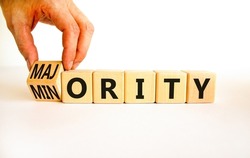 Minority or majority symbol. Businessman turns wooden cubes and changes the concept word Minority to Majority. Beautiful white background. Minority or majority and business concept. Copy space.