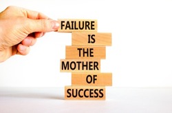 Failure or success symbol. Wooden blocks with words A failure is the mother of success. Beautiful white table white background. Businessman hand. Business, failure or success concept. Copy space.