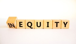 Inequity or equity symbol. Turned wooden cubes and changed the concept word Inequity to Equity. Beautiful white table white background. Business and inequity or equity concept. Copy space.