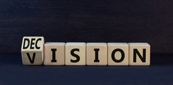 Vision and decision symbol. Turned wooden cubes and changed the concept word decision to vision. Beautiful black table black background. Business vision and decision concept. Copy space.