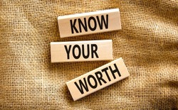 Know your worth symbol. Concept words Know your worth on wooden blocks. Beautiful canvas table canvas background. Business and know your worth concept. Copy space.