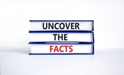 Uncover the facts symbol. Concept words Uncover the facts on books on a beautiful white table white background. Business and uncover the facts concept. Copy space.